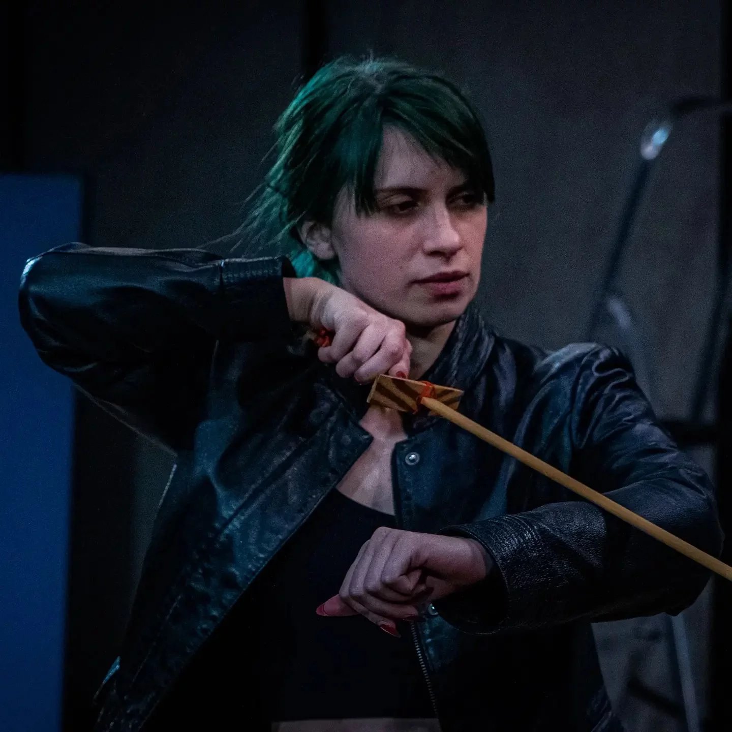 Billie-Jo as Captain in Queen Lear. She is holding a sword and is looking serious in a leather jacket.